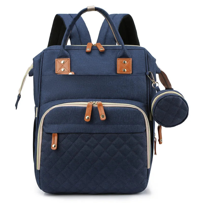 Organiza todo para tu bebé con la Mochila Pañalera Linden™: cambiador plegable, bolsillos térmicos, gran capacidad, separación húmedo/seco y diseño resistente al agua.