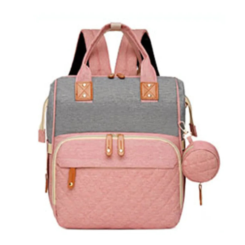 Organiza todo para tu bebé con la Mochila Pañalera Linden™: cambiador plegable, bolsillos térmicos, gran capacidad, separación húmedo/seco y diseño resistente al agua.