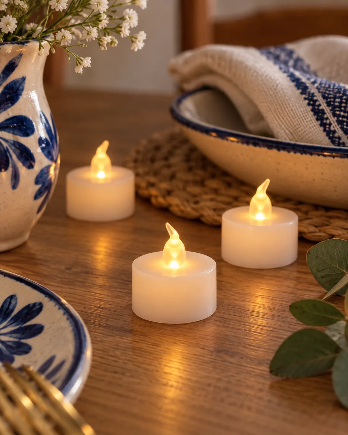 Velas LED sin llama Linden creando un ambiente cálido sobre una mesa decorada.
